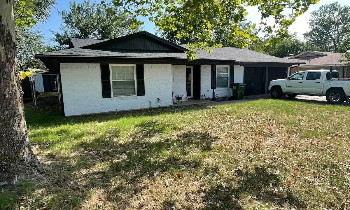 Professional roofing crew working on a residential roof in East Manchester